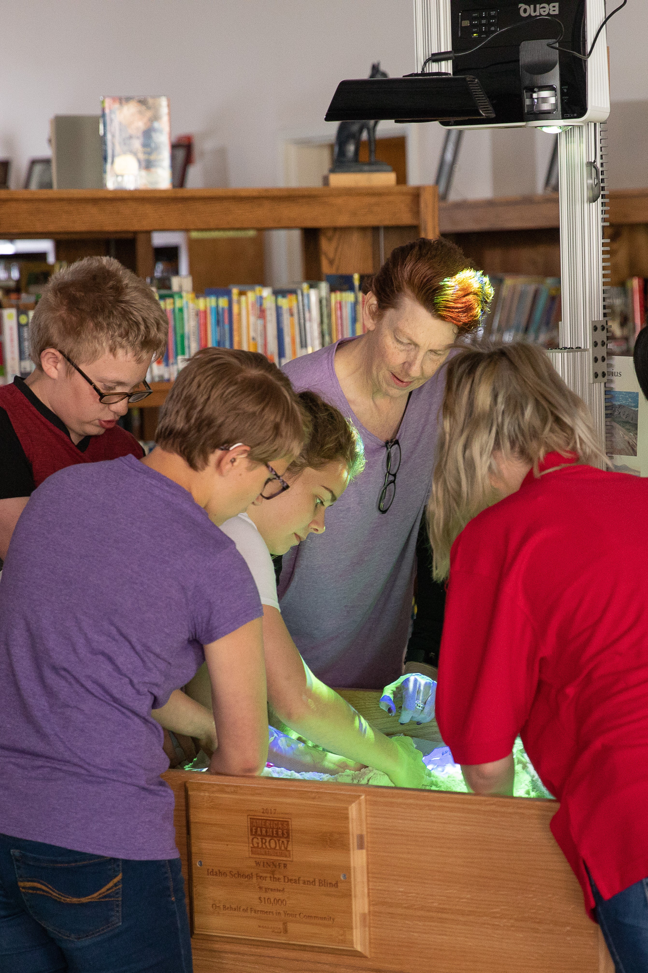 students explore with the augmented reality sandbox in the library