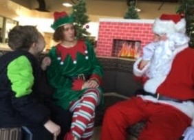 santa and his elf talk with student